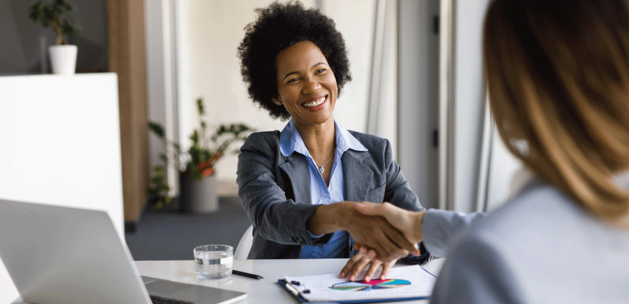 two women shaking hands in an office