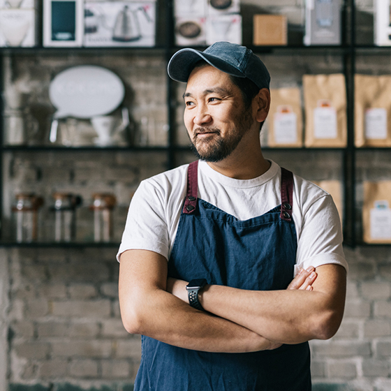 Man posing for a photo at a coffee shop