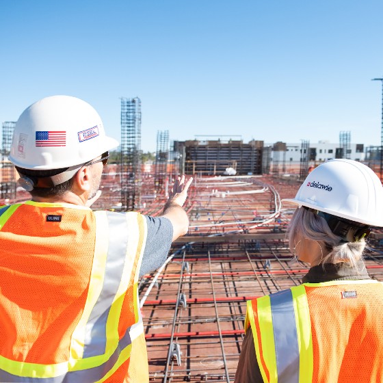 Construction workers looking out over new build