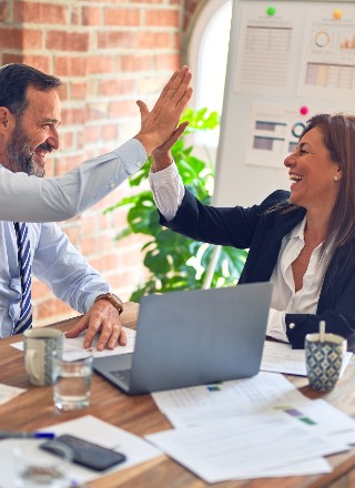 Two co-workers high-fiving