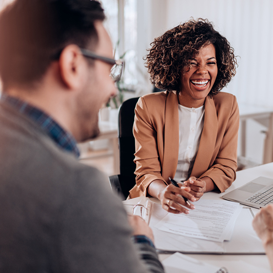 People laughing while at a business meeting