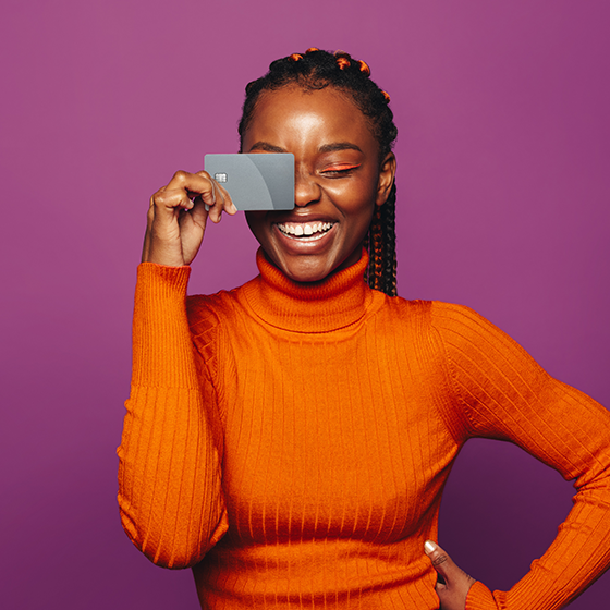 woman holding credit card on her face