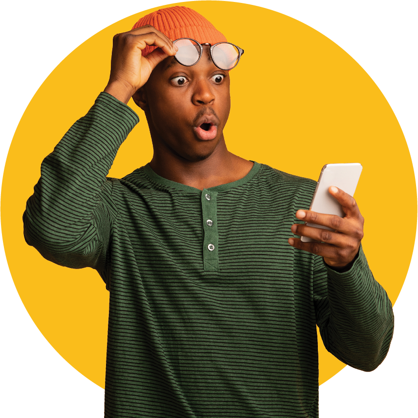 A man looking surprised at his cellphone