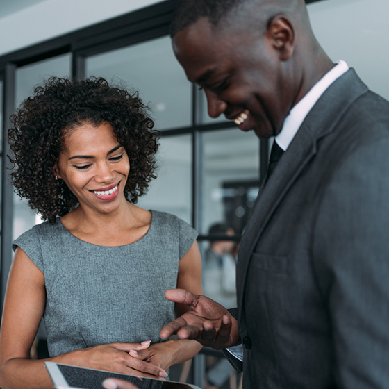 Business professionals view information on a tablet