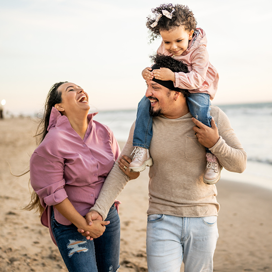 spanish family walking on the beach